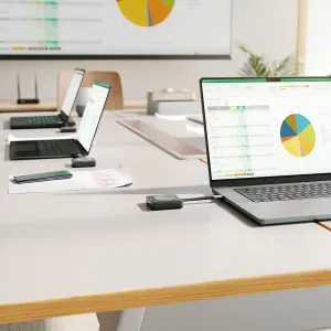 ALOGIC Unite 4K wireless presenter button with USB-C beside a laptop for slide control in meetings