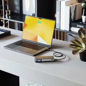 ALOGIC Ruck 20,000mAh power bank charging a laptop on a desk, with USB-C cable and display