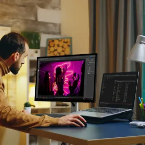 ALOGIC Clarity 5K Touch -näyttö työpöydällä kannettavan tietokoneen vieressä, kuvankäsittely avoinna kotitoimistossa.