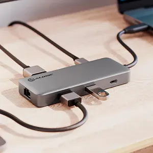 Alogic SPARK 6-i-1 USB4-hubb i rymdgrå med anslutna kablar på ett skrivbord, som visar USB-C- och USB-portar