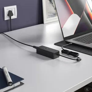 ALOGIC black 100W USB-C PD inline power adapter charging a laptop on a desk