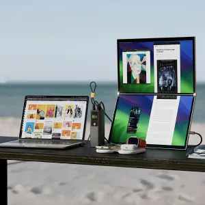 Alogic Ark Pro powerbank med skärm som laddar en bärbar dator, telefon och surfplatta på ett skrivbord