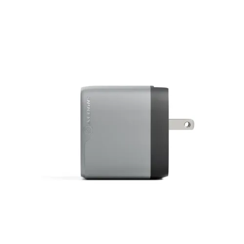 Compact wall charger in space gray with black front edge, side view with folded out US pins and ALOGIC logo embossed on the casing, side.