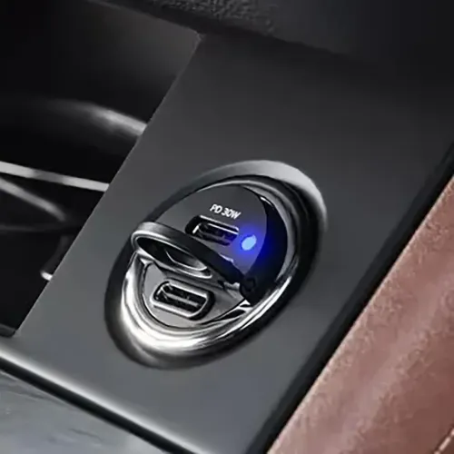ALOGIC Rapid Power car charger in cigarette socket, two USB-C ports labeled PD 30W and blue LED, shiny edge and compact profile.