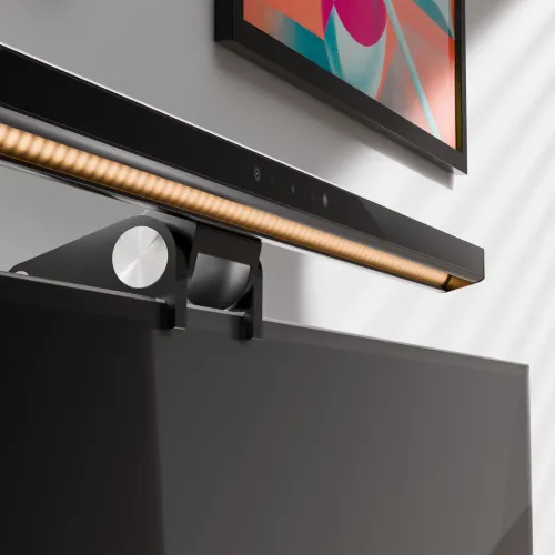 Ljusramp med inbyggd kamera monterad på bildskärmens kant med klämfäste och justerhjul, varm ljuslist och touchikoner.